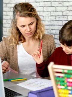 tutor helping child with math homework