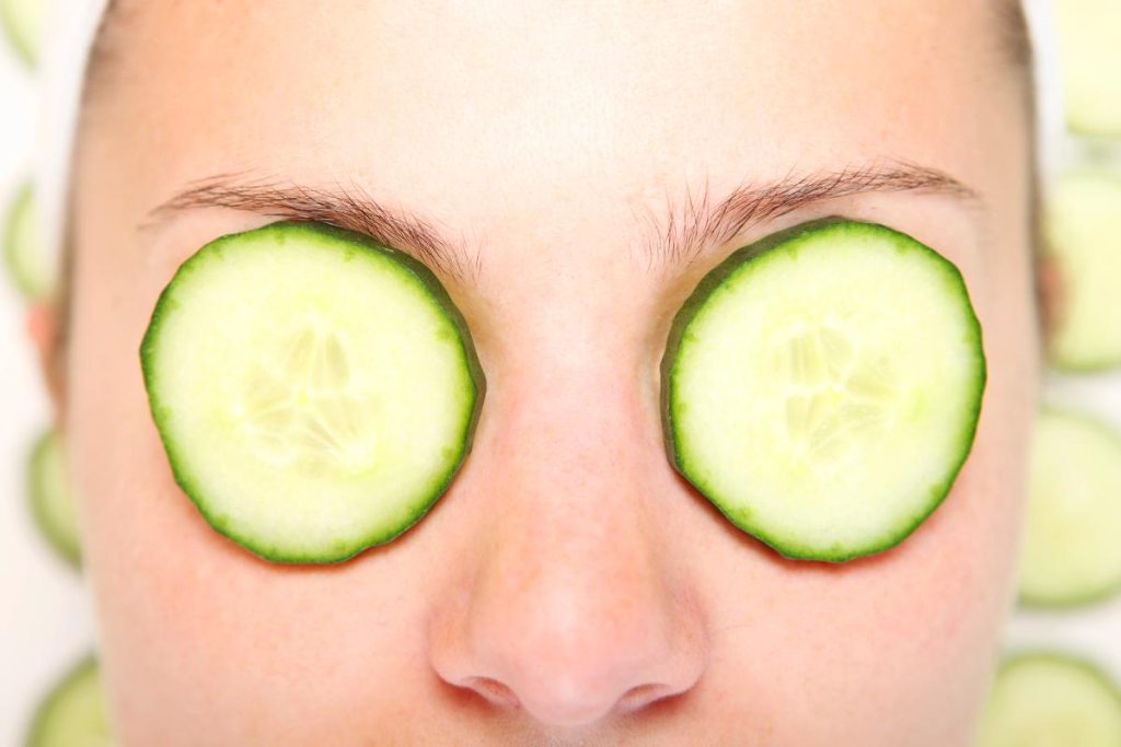 woman with cucumber slices on eyes