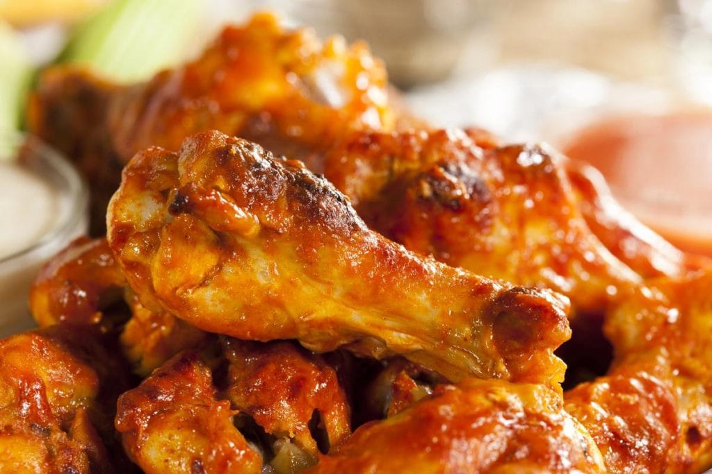 chicken wings covered in hot sauce