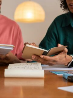 a couple with notebooks discussing finances