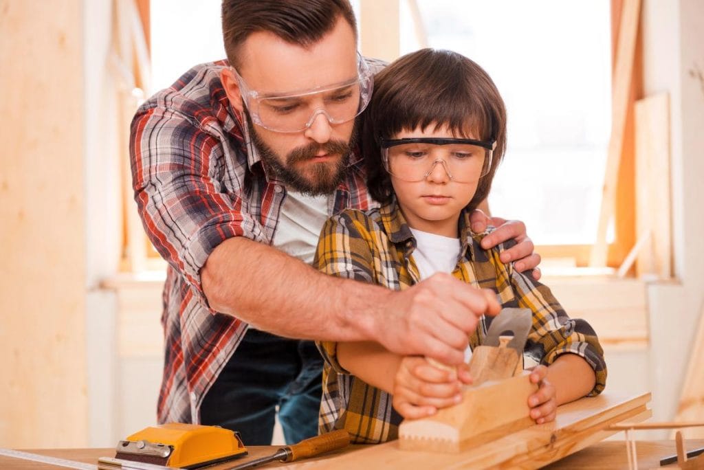 father and son working together on a woodworking project