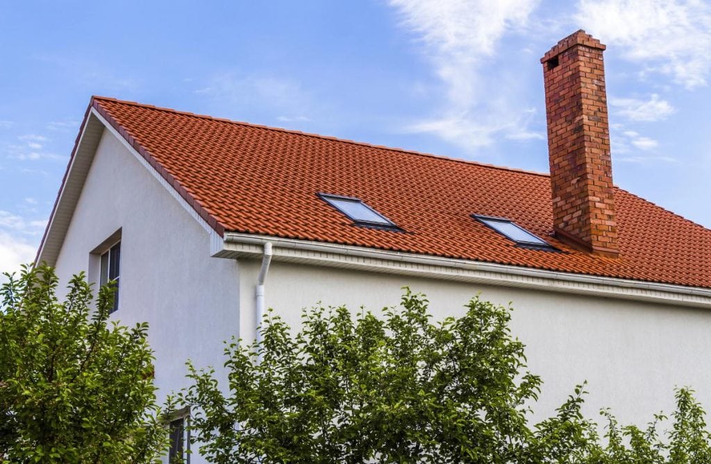 white house with a brick chimney