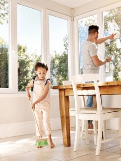 little girl helping dad with chores