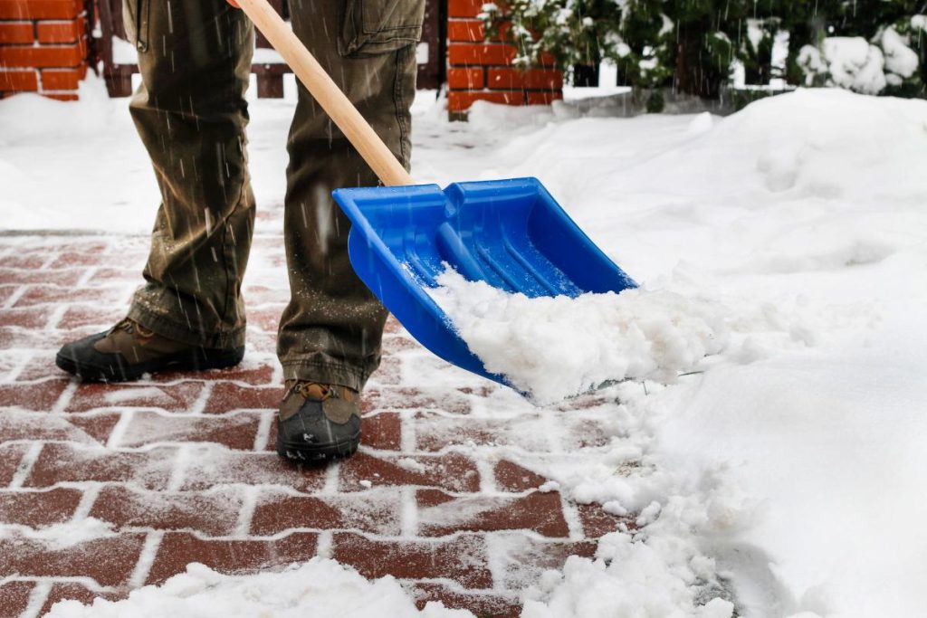 man shoveling snow from walkway