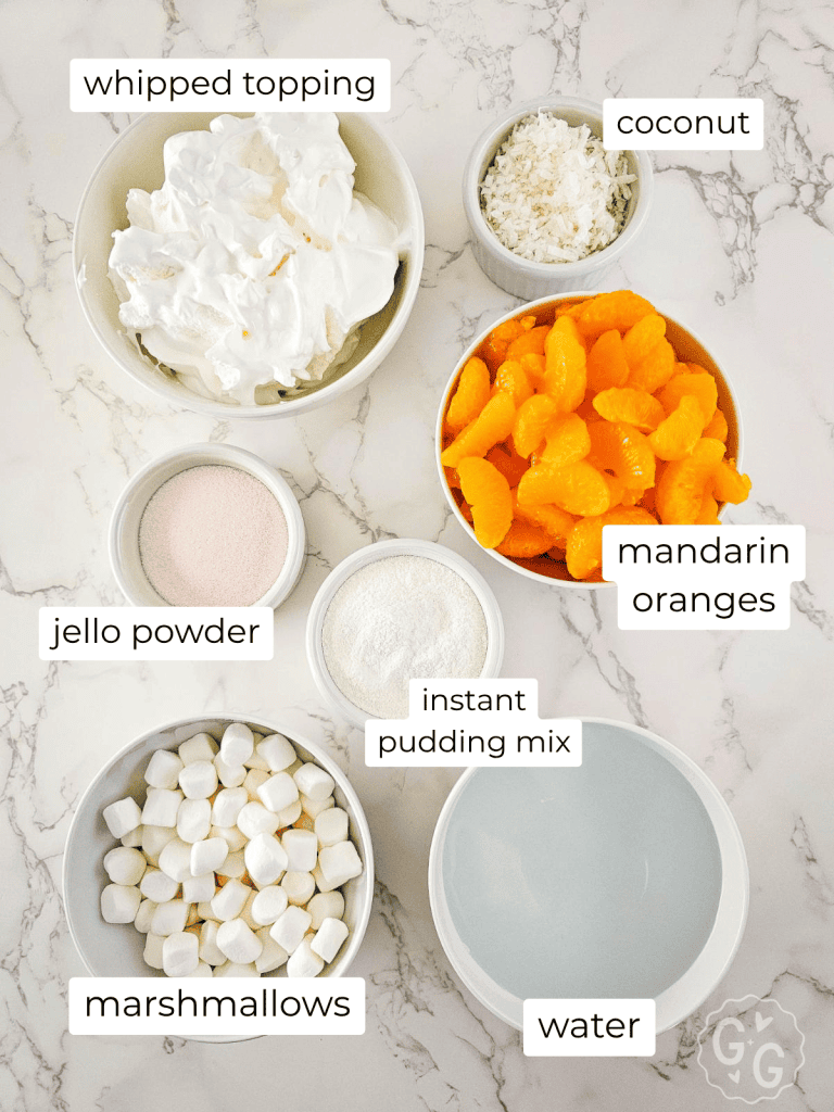 ingredients for making Mandarin orange jello salad - including mini marshmallows, orange jello powder, instant pudding mix, water, mandarin oranges, ococnut, and whipped topping