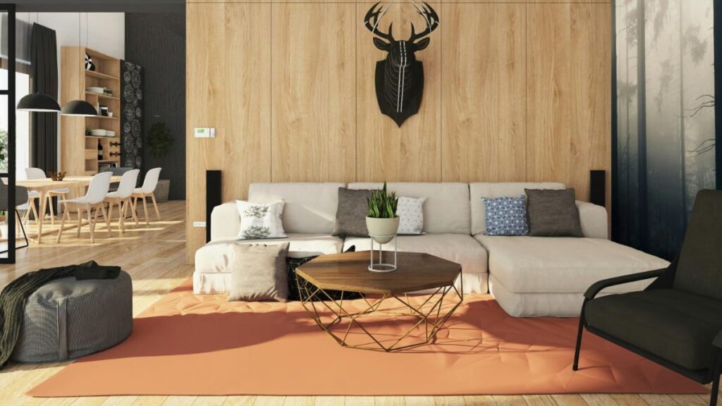 Contemporary living room with a neutral sectional sofa, geometric wood coffee table, assorted accent pillows, and a black stag wall art, designed for stylish entertaining.