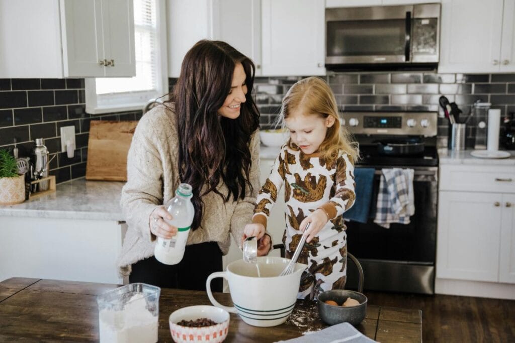 mom cooking with daughter in the kitchen