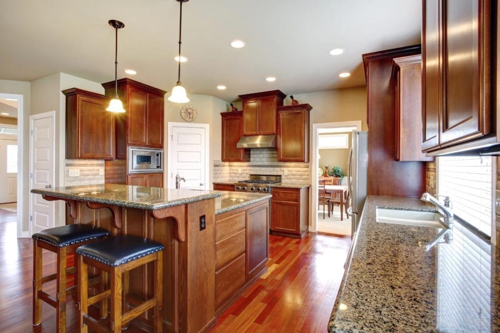 oak cabinets and granite countertops in a warm kitchen