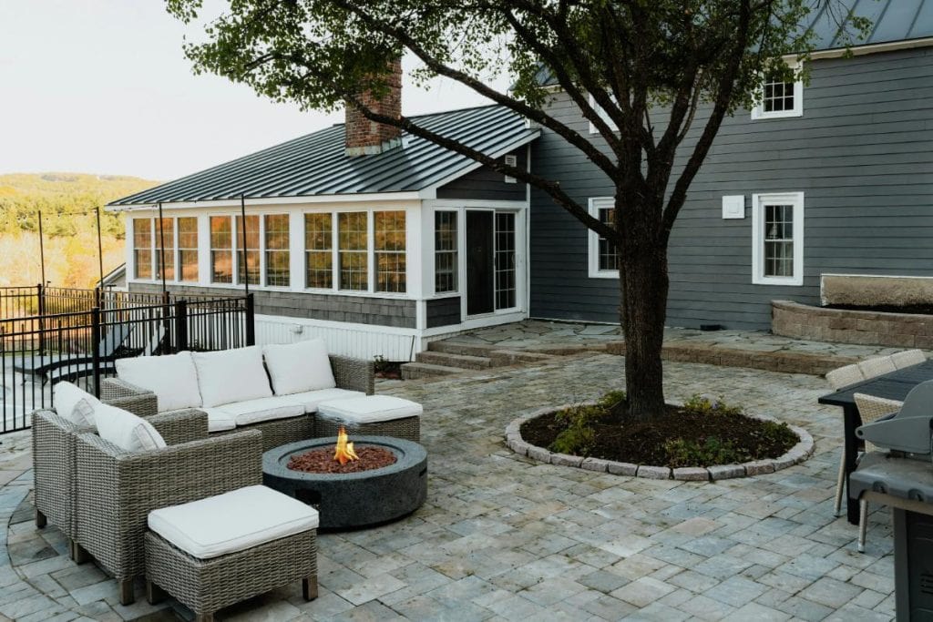 a patio with an outdoor seating area and fire pit, highlighting the need for patio organization and zones for a great outdoor experience
