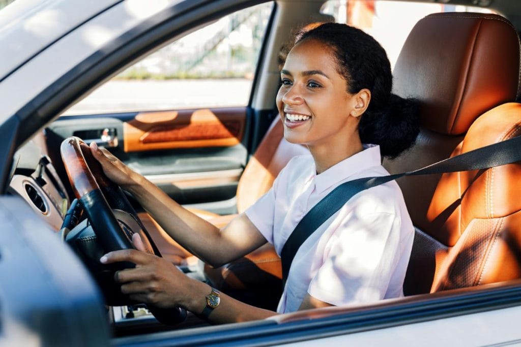 smiling woman driving a car