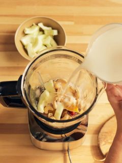 pouring smoothie ingredients into a blender - top down view