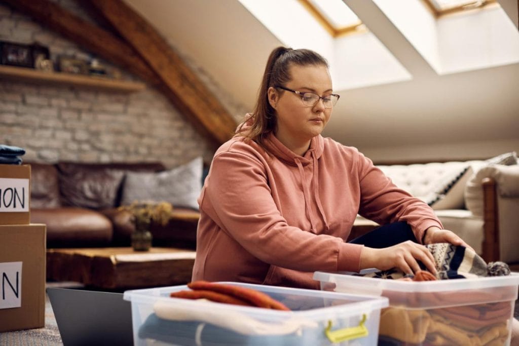 woman going through belongings to get rid of what she doesn't need