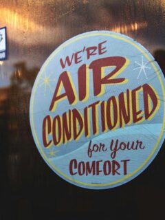 sign on business that reads air conditioned for your comfort