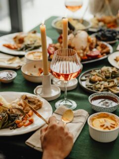 family and friends enjoying a Thanksgiving meal together - hosting dinner brings people together