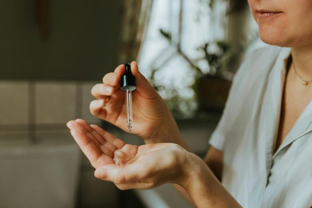 woman applying a serum to skin