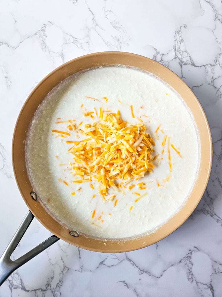 Shredded Colby Jack added to the cream-cheese sauce for jalapeño popper casserole.