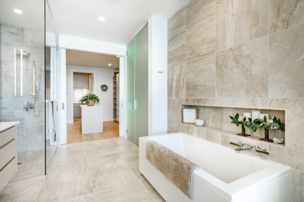 a brightly lit bathroom with a large tub and separate walk-in shower