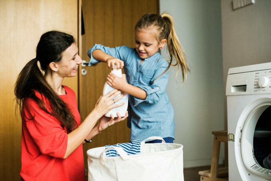 girl helping with laundry