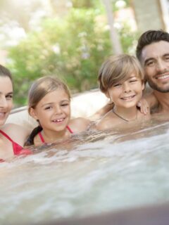 a family of 4 enjoying some hot tub time together