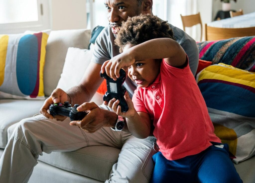 father and son playing video games together