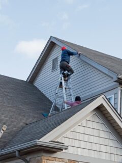 a man working on a gabled roof