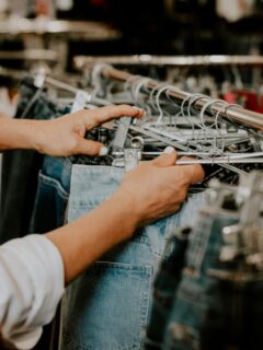 woman looking through clothing racks