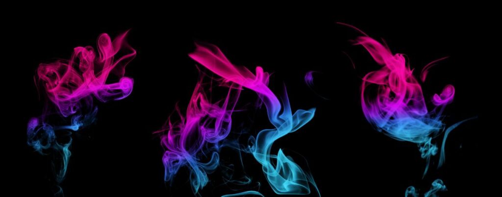 Vibrant swirls of pink, purple, and blue smoke rising against a black background, showcasing the dramatic visual appeal of coloured smoke effects.