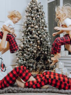 family of 4 in red and black plaid christmas pajamas