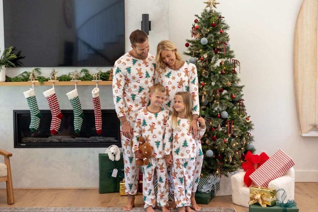 Family of 4 in matching gingerbread pajamas for Christmas
