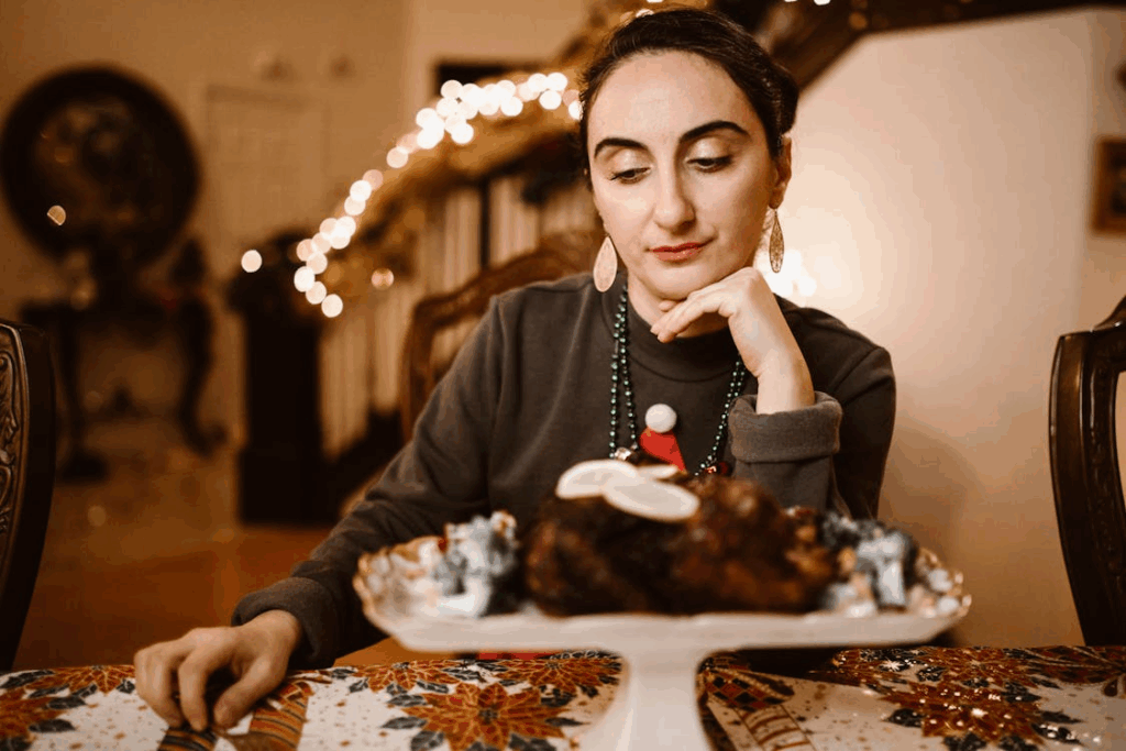 a woman looking unhappy sitting at the holiday table