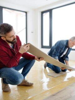 father and son installing flooring