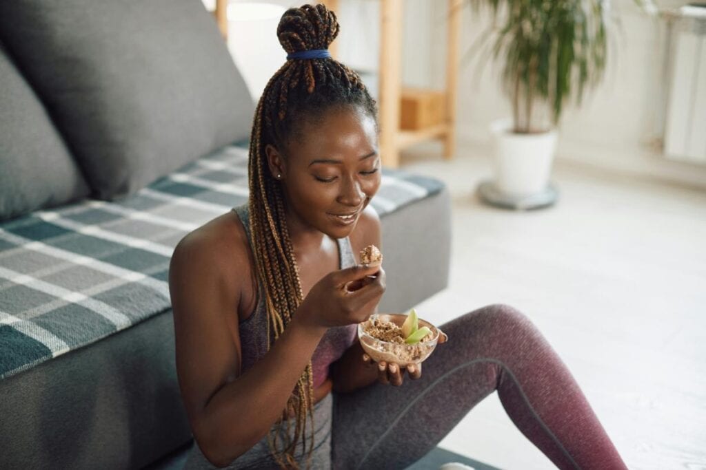 a young woman eating a healthy snack to fuel a workout