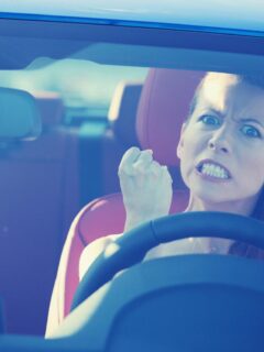 angry female driver making a fist out of frustration