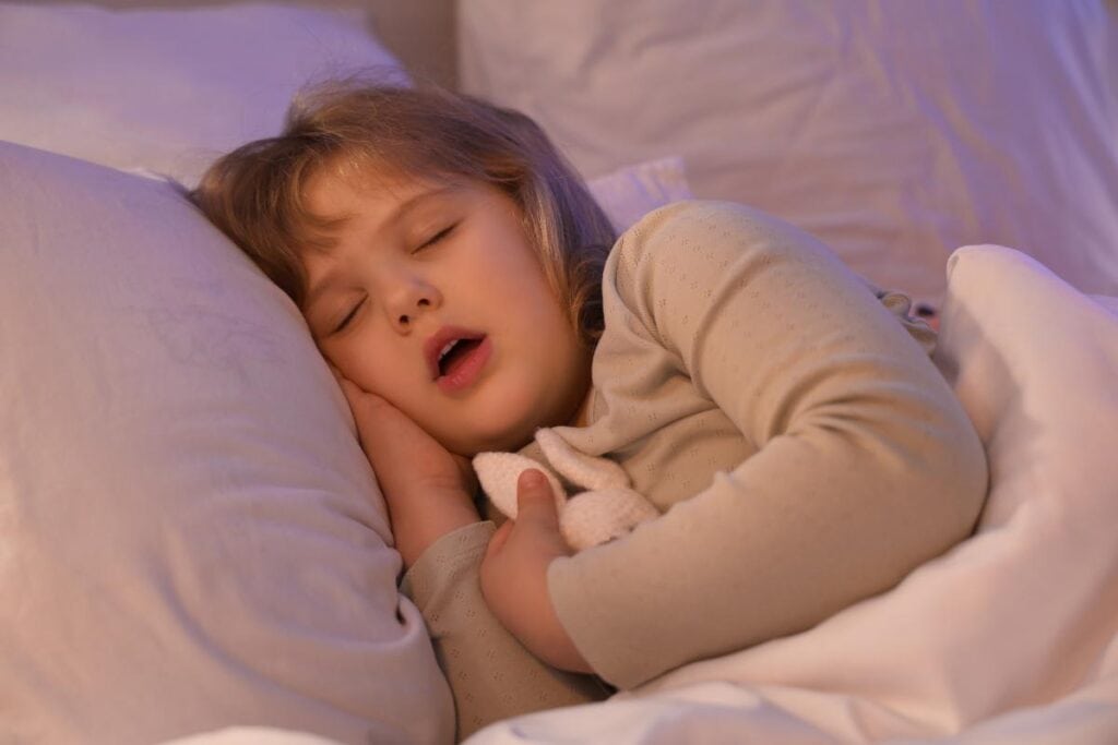 little girl asleep and hugging a plush bunny