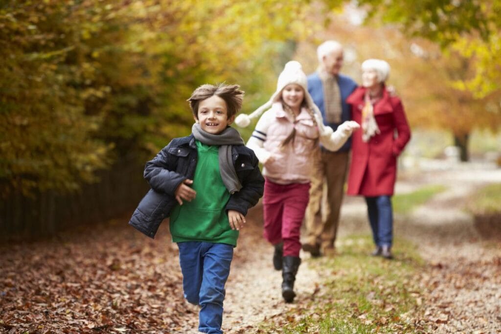 grandparents and grandchildren on a walk in autumn