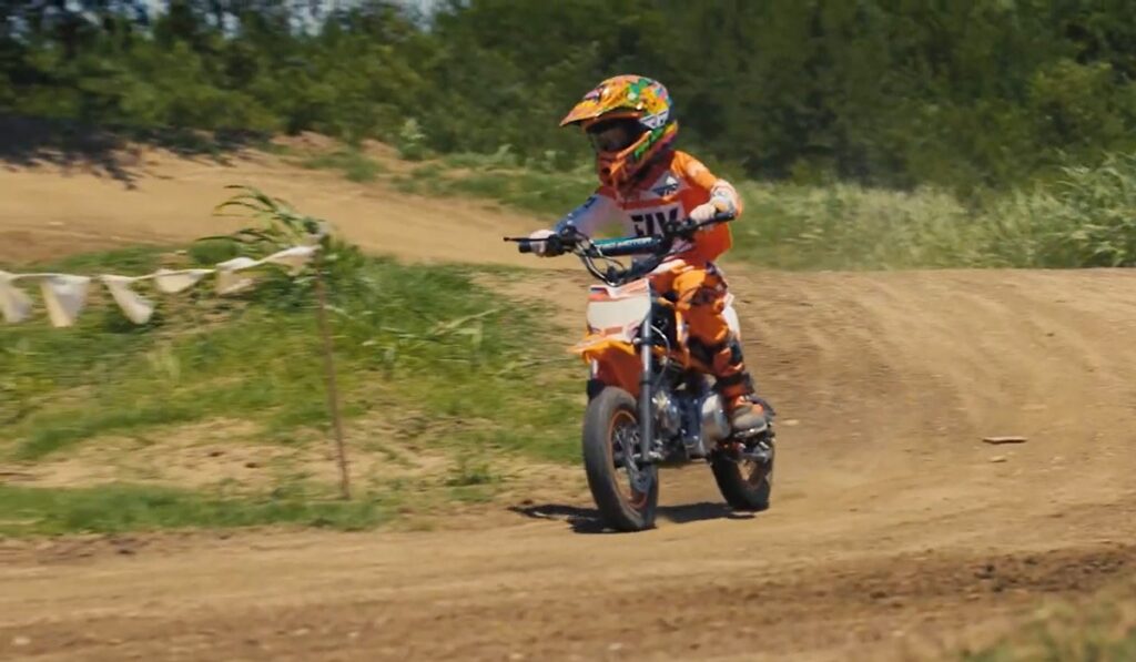 Youth motocross rider on dirt track