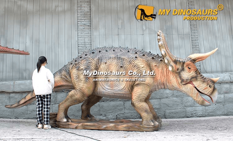 female standing in front of animatronic dinosaur from My Dinosaurs