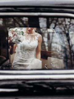 looking at bride through vehicle window