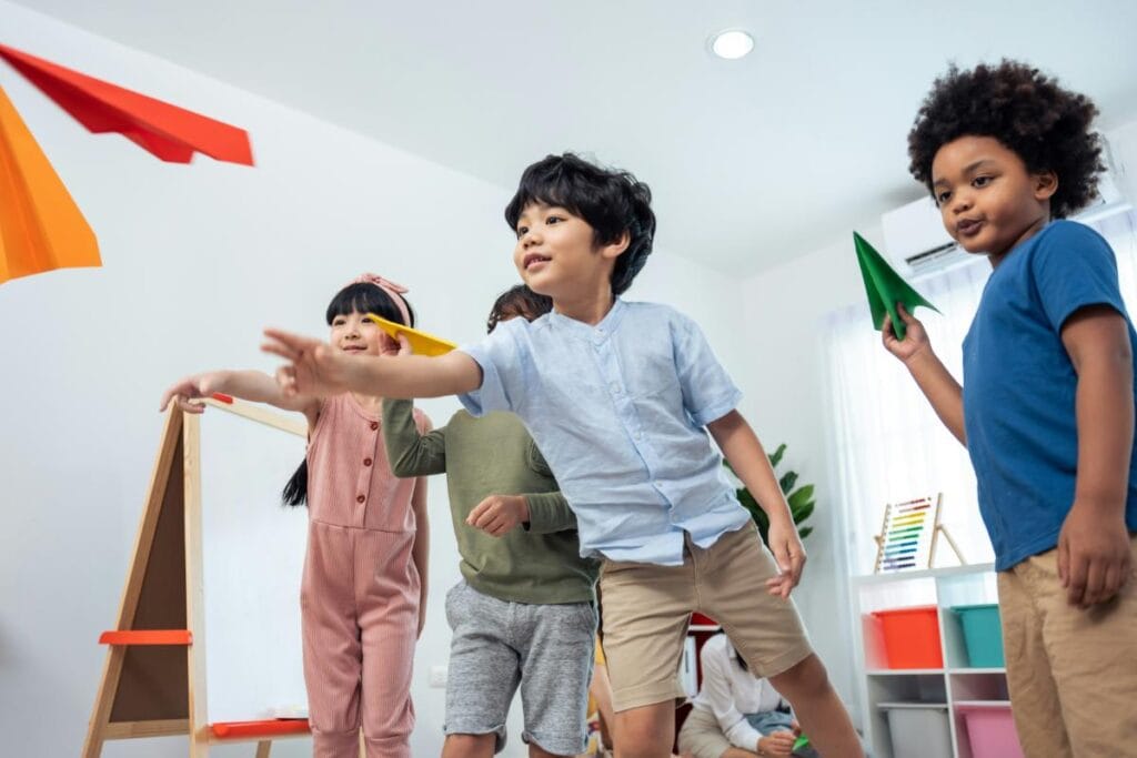 kids playing with paper airplanes on a rainy day
