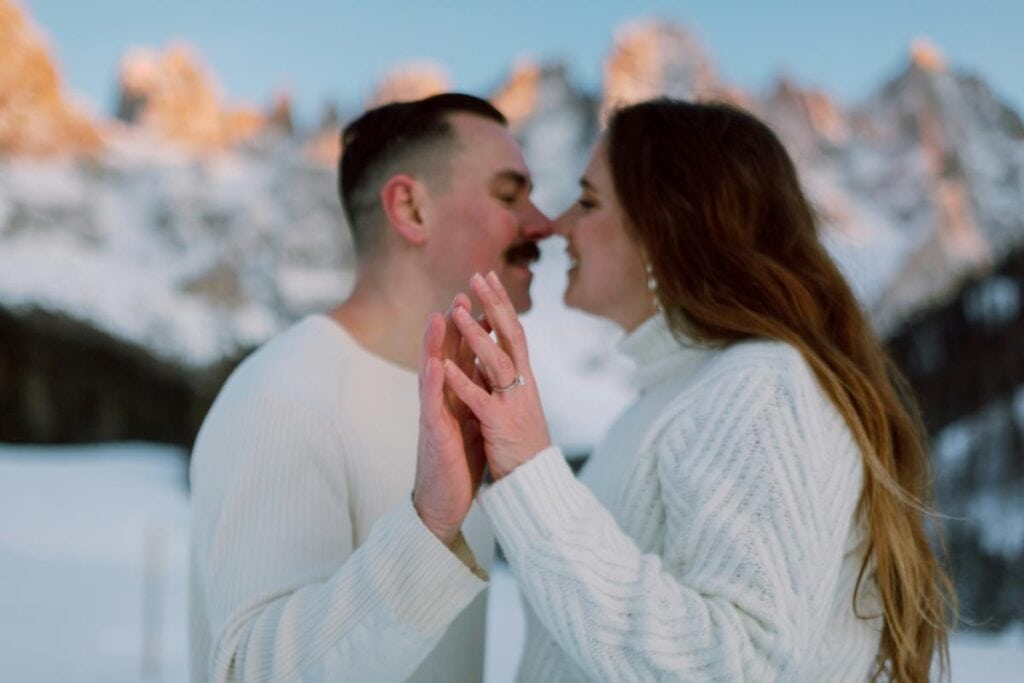 couple holding hands posing for an engagement picture after a successful proposal