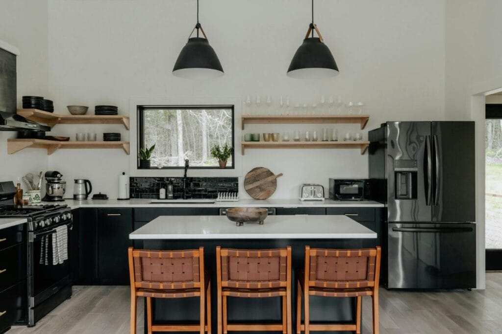 a beautifully renovated black and white kitchen