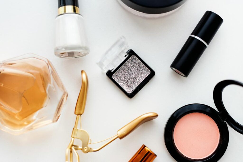 beauty products and accessories on a white flat lay surface