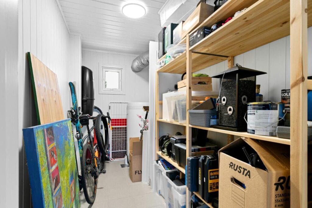 a narrow storage room filled with household belongings