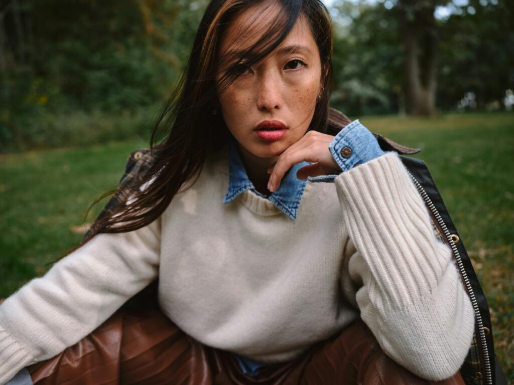 Woman wearing a layered outfit with a sweater and jacket, showing a polished casual look suitable for busy days.