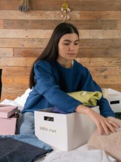 a woman boxing clothes to put into storage