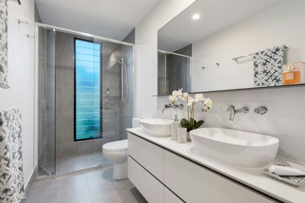 a beautifully remodeled bathroom with bright surfaces