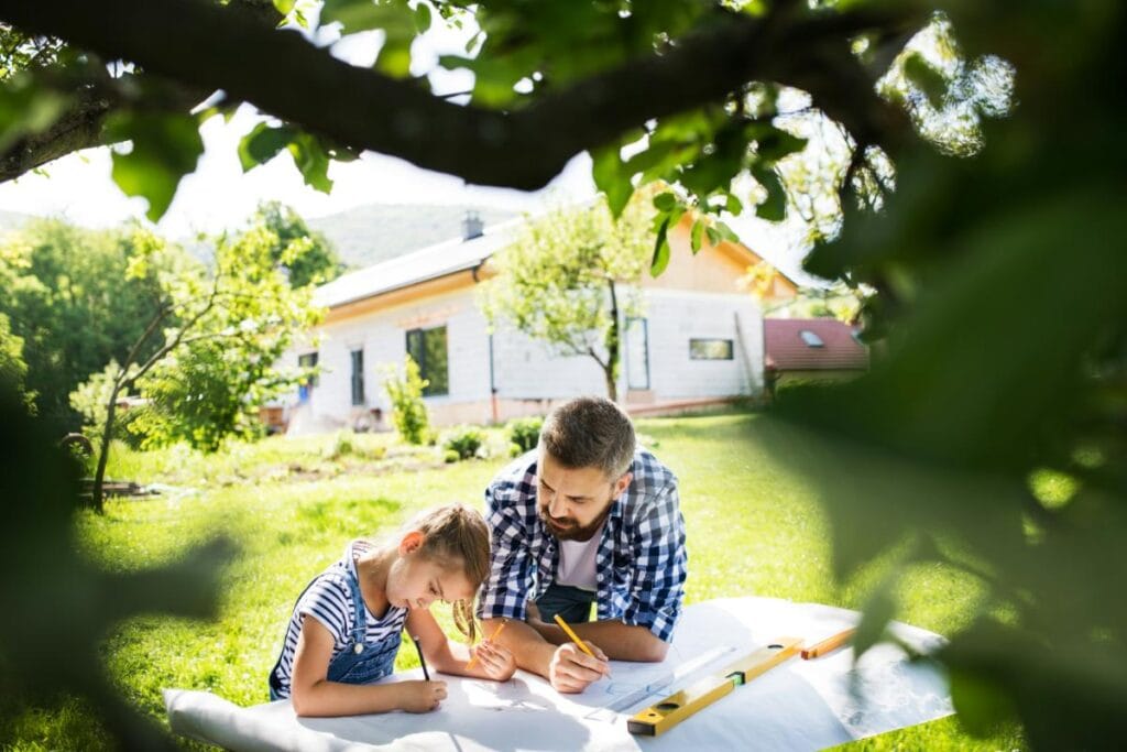 a father and daughter drawing out plans for a DIY project