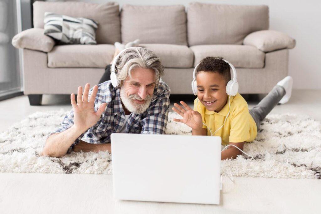 grandfather and grandson watching video on laptop