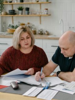 a couple reviewing their finances at the kitchen table