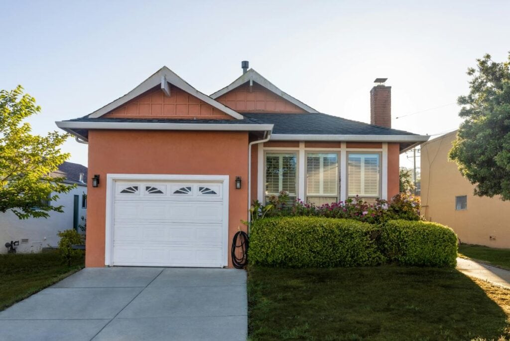 Single-story suburban home with garage door and driveway, representing residential garage door repair and maintenance services